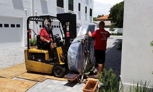 Two Men Carefully Moving a Piano | 3GuysMoving.com