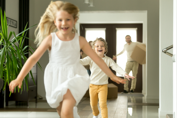 Two Children Running into New House Followed by Parents | 3GuysMoving.com